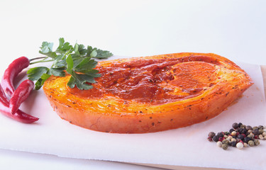 Raw Pork ham with spices, parsley leaves and chilli ready for BBQ grilling isolated on white background.