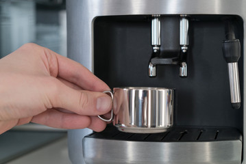 Coffee machine with a metal mug, close up