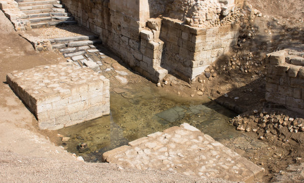 Jordan River Baptismal Site of Jesus Christ at Bethany. The ancient structure is made of stone blocks with stairs leading to small tributary of nearby Jordan River. Photographed from above.