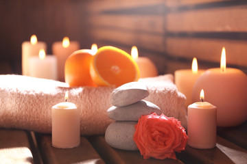 Beautiful spa setting with candles on wooden background