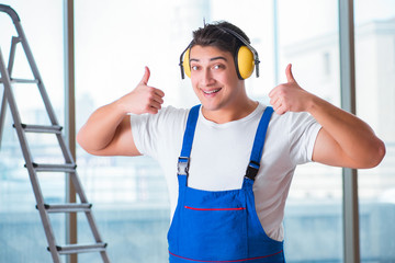 Worker with noise cancelling headphones