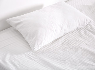Fototapeta na wymiar White orthopedic pillow on bed