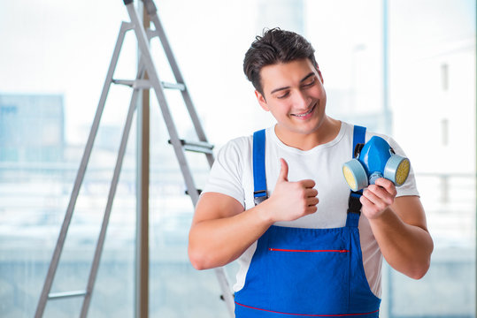 Young worker with protective face gas mask