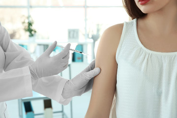 Doctor vaccinating patient in clinic