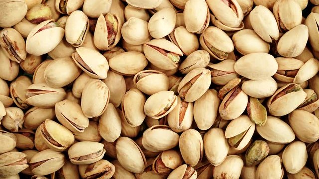 Food background. Roasted pistachio nuts seed with shell close up. Dieting concept. Rack focus 4K ProRes HQ codec