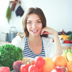 Young woman standing near desk in the kitchen