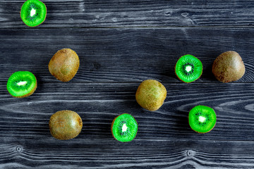 exotic fruit design with sliced kiwi on dark table background top view