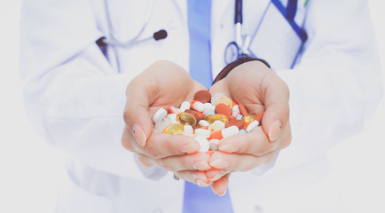 Doctor holding heap of drugs in a hand