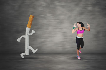 Fototapeta na wymiar Scared woman running away by a cigarette
