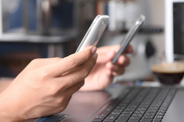 Hand holding two smart phone to sharing and link data