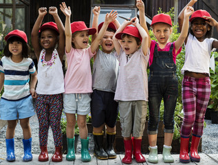 Group of kindergarten kids little farmers learning gardening