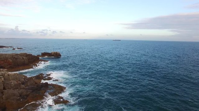 Aerial view of rocky ocean coast at evening