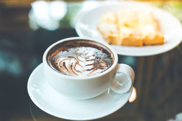 Hot chocolate art with coffee cup and ham cheese bread