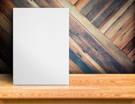Blank White paper poster on wooden table at diagonal wood plank wall,Template mock up for adding your design and leave space beside frame for adding more text