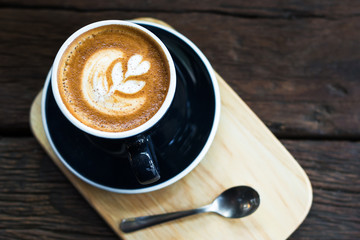 A cup of coffee cup on a wooden table