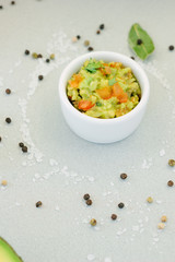 Traditional mexican avocado - vegetarian dip surrounded by its ingredients.