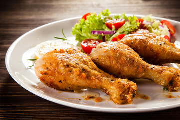 Grilled chicken drumstick on wooden table