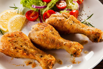 Grilled chicken drumstick on wooden table