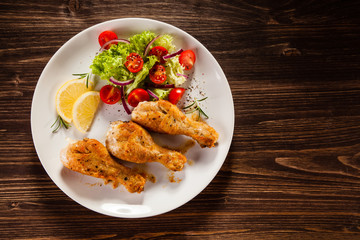 Grilled chicken drumstick on wooden table