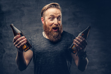 A man holds beer bottle.