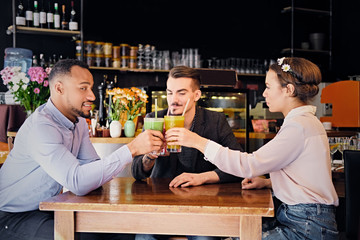 Friends drinking coctails in a cafe.