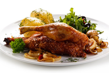 Roast duck with potatoes on white background