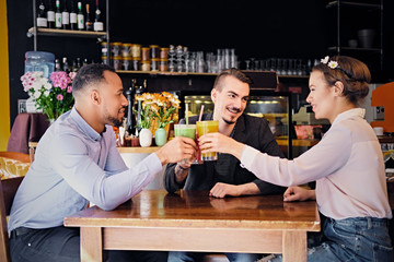 Friends drinking coctails in a cafe.