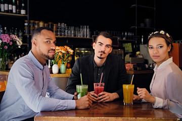 Friends drinking coctails in a cafe.