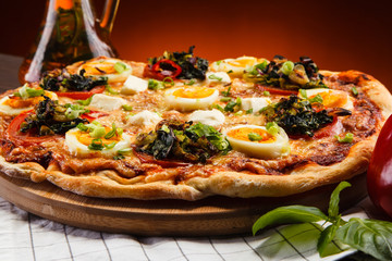 Pizza pepperoni with egg on wooden table