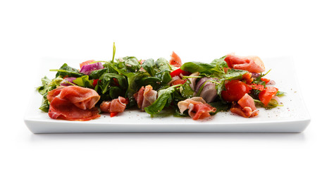 Salad with smoked ham on white background