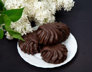 White lilac with chocolate on black background