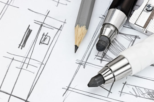 designers working tools on graphical sketch of modern room interior