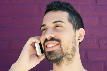 Latin man talking on the phone