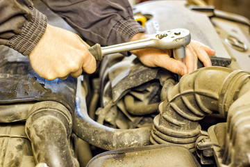 the mechanic of the hood of a car repair