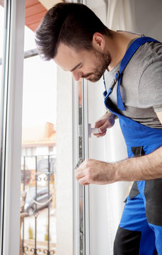 Young Handyman Repair Window