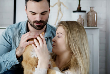 Happy couple with cat at home