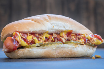 Grilled hot dogs with mustard, ketchup and dill pickles