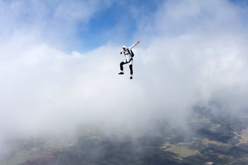 Fototapeta na wymiar Skydiver is sitting on the cloud.