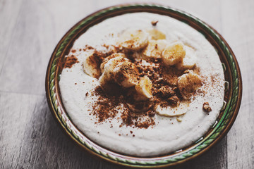 ice cream with bananas and nuts on aged background