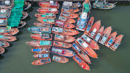 Fototapeta na wymiar The big fishing boats standing at the sea in Phuket, Thailand