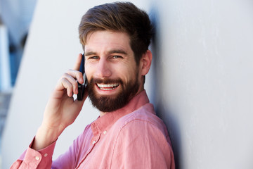 laughing man having conversation on smart phone