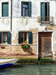facade of the house along the canal of Venice, Italy