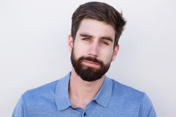 Obraz premium Close up handsome young man with beard against white background