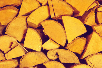 Photo of chopped firewood texture in warm tone