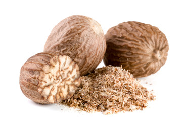 Three nutmeg and powder isolated on white background