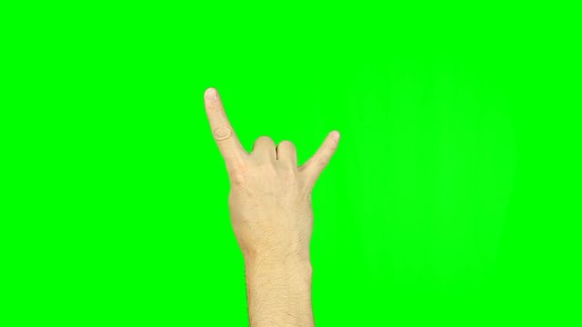 Sign of the horns with fingers on green screen. Simbol of heavy metal rock. Gestures with fingers of one hand. Caucasian young man. Footage contains solid green instead alpha channel easy keying.