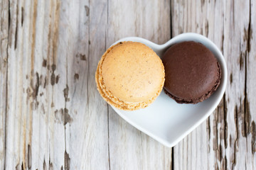 Beautiful homemade macaroons on wooden table. Natural light, selective focus. 