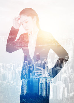 double exposure of  business woman worried with city background