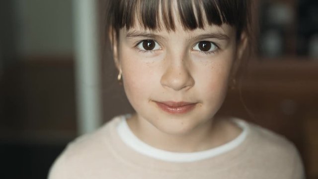 Teenager brunette girl looking to the camera, portrait of happy kid