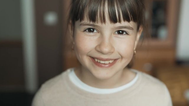Portrait of teenager girl changing facial expressions from serious to smiling, happiness concept